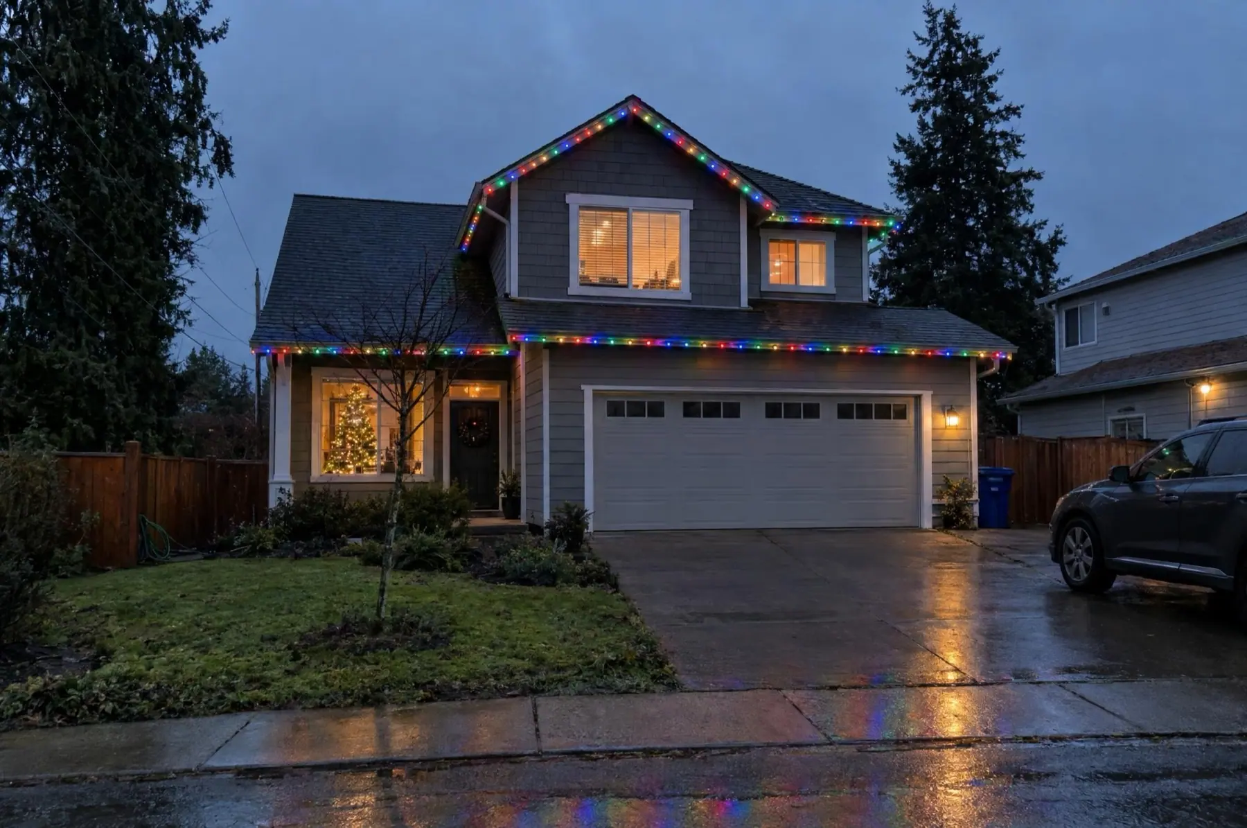 Illustration of a two-story home with multicolor holiday roofline lights